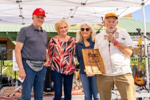 A picture of the members of PPEP INC presenting an award to someone on stage at the Amado Chili Cookoff event.