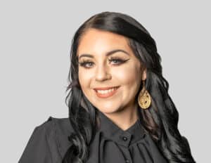 A headshot of a woman with black hair against a white background.