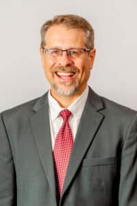 A business headshot against a white background.