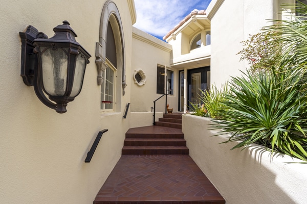 A real estate photo of a beautiful white entryway to a house.